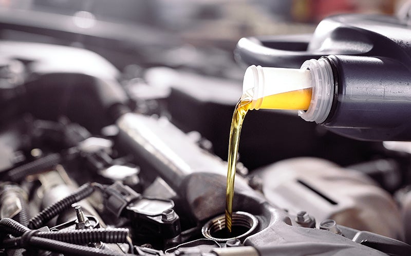 Mechanic checking car engine